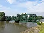 Side view of the iron truss railway bridge over Mura River in Mursko Središće, Croatia