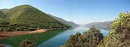 Lake with surrounding tree-covered hills