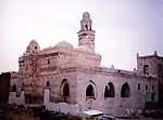 A mosque with a minaret in white