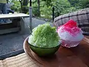 Green tea Kakigōri(left) and strawberry flavoured Kakigōri(right).