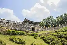 Fortress walls and a gate on the top of a hill