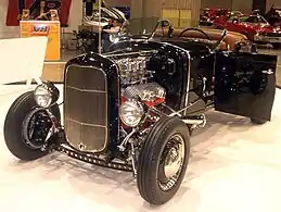 '31 A roadster with '32 grille shell (a common change), 3 deuces, Lake pipes, drilled I-beam, custom  windshield, custom drum brakes with finned rear covers, & custom hairpins.