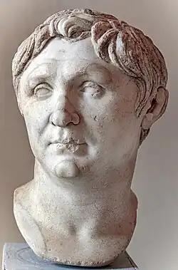 Marble portrait bust of a young man with short hair.