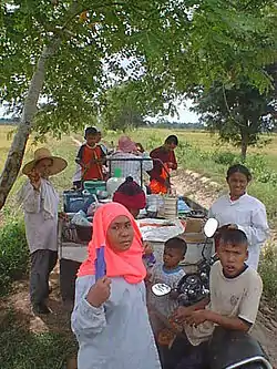 Family working on rice farm in Ban Sam Ruen