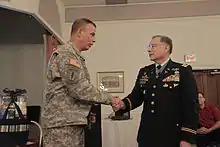 U.S. Army Col. Edward Rothstein, left, shakes hands with Medal of Honor recipient Lt. Col. Alfred Rascon at the Fort Meade Community Soldier/Family Resiliency Fair in Maryland Sept. 20, 2011.