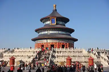 A multi-level circular building at the top of white staircases.