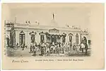 Black and white historic postcard of "Marta Abreu" station, circa 1900. People gathered outside the main gates.