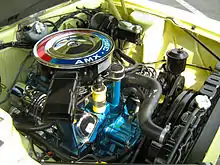 The 390 cd V8 engine in a FR 1968 AMC AMX functionally straddles its front axle, with the centerline of the shock towers basically bisecting the center of the air cleaner