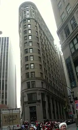 A photograph of the Beaver Building, a flatiron shaped construction