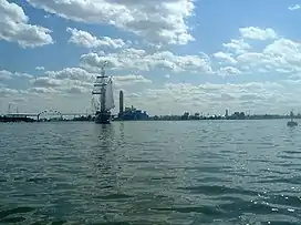 The tall ship, Windy II sails from Green Bay south into the mouth of the Fox River under the Leo Frigo Memorial Bridge in Green Bay, Wisconsin.