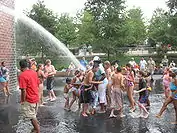 The fountain spouting water on frolicking children