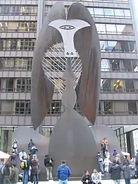 A large sculpture with kids climbing on it