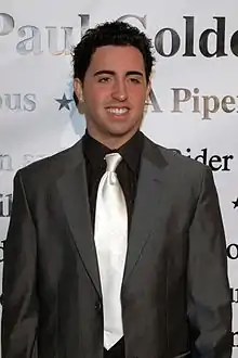 Colby O'Donis is smiling away from the camera.