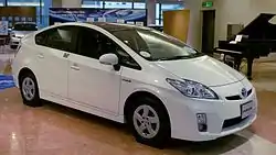 A white Toyota Prius sedan is on display.