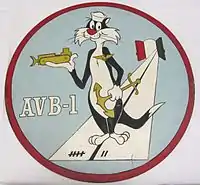 A This insignia was adopted in 1960. It features Sylvester the Cat wearing devices representing the three categories of naval personnel which make up the crew of an AVB: aviation, line, and Seabees. This ship's mission is represented by the runway, which emanates from two doors, symbolizing the bow doors of the ship. The colors on the doors are those of Italy where Alameda County is home ported. The runway markings represent the year (1957) in which this ship was designed AVB-1. Permission to use this copyrighted character was granted by Warner Brothers.