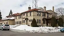 Sprawling, two-story brick building on a snowy corner