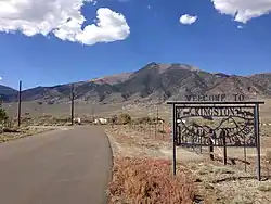 Entrance to Kingston from Nevada State Route 376. Bunker Hill is visible in the background.