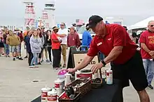 Paul Petrisko, Community Coffee retail sales representative, setting up promotional display at an event in Cherry Point, N.C.