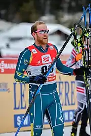 Phillip Bellingham standing on snow with ski-gears