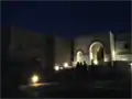 Night-time view from lower courtyard toward main chapel and upper courtyard entrance.