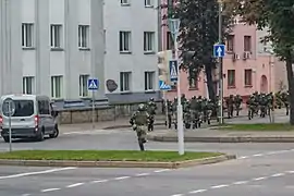 Running internal troopers in Minsk. Note the van with darkened glasses and without the registration plate: such vans are reported to be used by the government forces to bring reinforcements and detain people