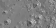 Close view of expanded craters, as seen by HiRISE  After the impact, ice left the ground and made the crater larger in diameter.