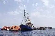 MS Sea-Watch surrounded by refugee boats and life rafts while it waits for assistance on 5 July 2015