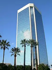 low angle shot of modern all–glass office building in downtown Phoenix.