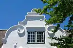 The house is T-shaped with straight end gables and a concavo-convex front gable. This property was sold to Magteld Combrink in 1801, and she probably had the Cape-Dutch house erected shortly afterwards. Type of site: House Previous use: Residential. Current use: House.