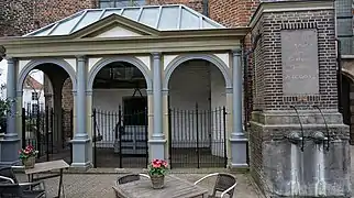 Weighing scales and village pump on the market square in Buren.