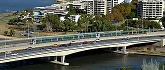 Train on bridge in freeway median