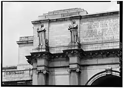 Detail of the west end of the main entrance pavilion, showing statuary and inscription