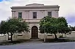 Three bay facade divided into two storeys. Cornice and entablature small pediment. Heavy pilasters. Small pane sash windows. Round arched front double door. Shaw Hall was built as a Methodist Church at a cost of R6 000. It was inaugurated on 16 December 1832, and was known as the "Wesley Chapel". It had galleries along three sides and could seat about 800 people. It was used as a church until the Commemora. Neo-classical building erected in 1831 and dedicated on 16 December 1832. Named after the Rev. William Shaw, founder of the Methodist Church in South Africa. Cape Parliament was opened in this building on 28 April 1864.