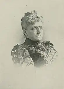 B&W portrait photograph of a middle-aged woman with her hair in an up-do