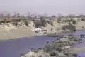 Two men are drying their washed clothes on a bank of the Falémé River at the Mali-Senegal border, 1984.