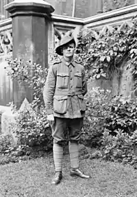 a black and white full length portrait of a man in uniform