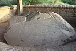 A large boulder with carved inscriptions