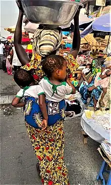 A woman selling water in Makola