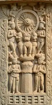 A depiction of a Dharma wheel held up by lions, one of the pillars of Ashoka