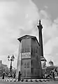 Encased equestrian statue of Charles I in Trafalgar Square with a notice giving directions to the nearest public air raid shelter