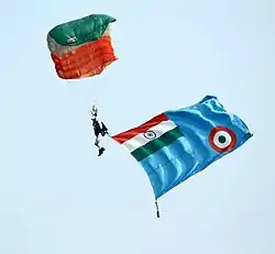 Akash Ganga Sky diving team member carrying the Indian Air Force Flag