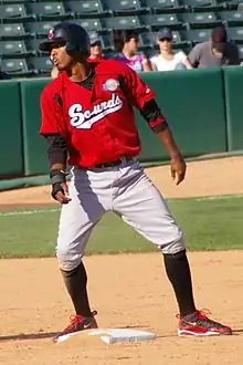 A baseball player in red and gray