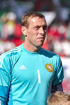 A man wearing a light blue football jersey.