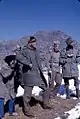 Alice Kandell hiding behind a Sikkimese soldier to take a photograph of a Chinese soldier along the Nathu La Pass, Sikkim