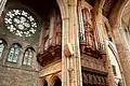 The double-fronted gothic organ case, designed by the architect's son, and north transept (rose) window