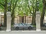 Gates, railings, piers and gate piers with lamps fronting Buckingham Gate and as entrance to Ambassadors’ Court