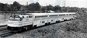 A locomotive leading several railcars