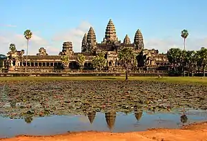 Ruins of a large structure with five large towers at the top.