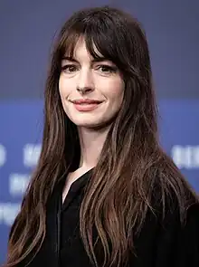 A head shot of Anne Hathaway as she smiles for the camera