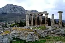 Image 29Ruins of the Temple of Apollo within the polis of Ancient Corinth, built c. 540 BC, with the Acrocorinth (the city's acropolis) seen in the background (from Archaic Greece)